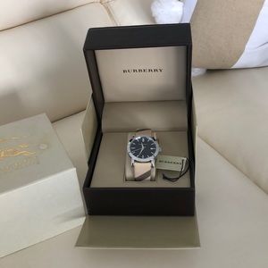Burberry watch never worn.  Still in box